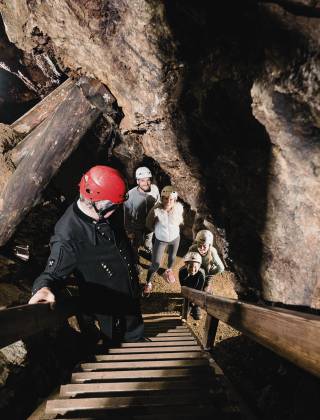 Family with guide in typical miner's uniform in the Barbarastollen