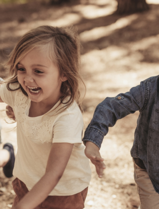 Laughing and running children in the forest