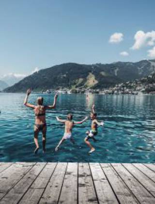 Family swimming in Lake Zell during a summer holiday in Salzburger Land