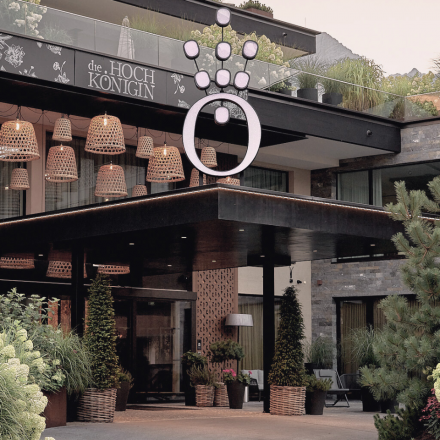 Hotel entrance with many plants and flowers in the HOCHKÖNIGIN