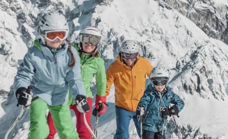 Family in the snow in the mountains skiing