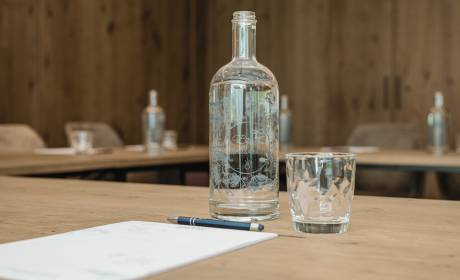 Water bottle Glass and writing pad in the seminar room in the HOCHKÖNIGIN