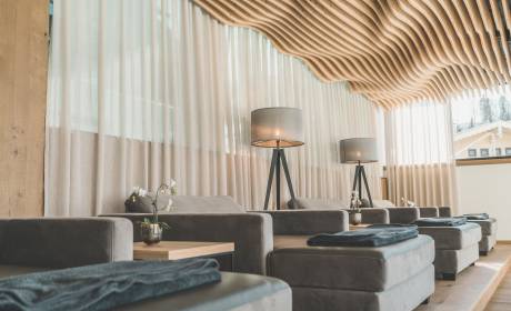 Relaxation area in the HotelSPA with cosy loungers and unusual curved wooden ceiling