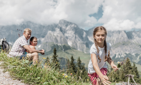Family in the alpine meadow in the mountains