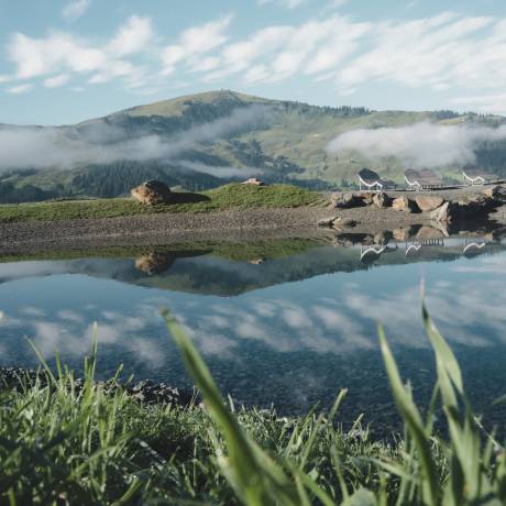 Summer in the mountains with a view of the surrounding mountains from the mountain lake