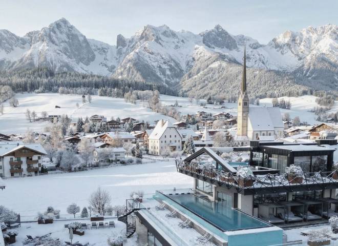 Winter panorama of Maria Alm at Hochkönig featuring the wellness hotel die HOCHKÖNIGIN, snow-covered alpine village, church and mountain scenery in Salzburg, Austria – luxury winter holiday, wellness hotel in the Austrian Alps