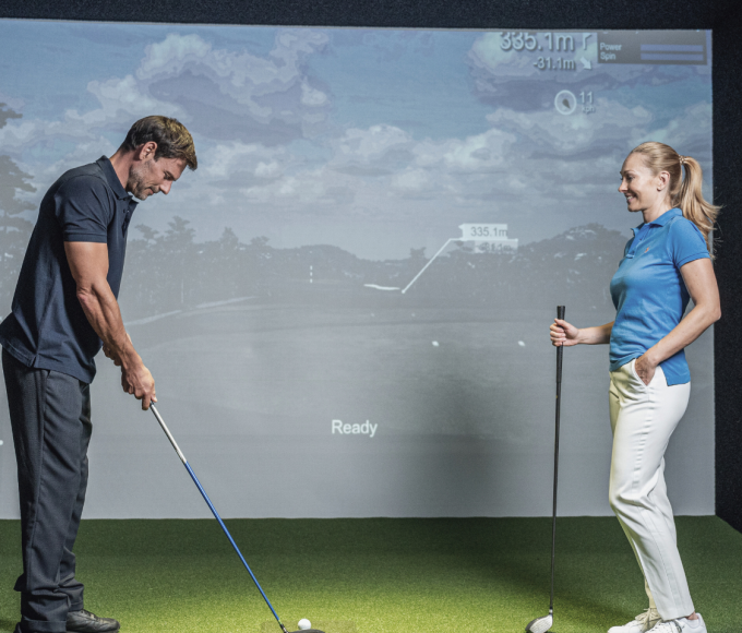 Couple playing indoor golf
