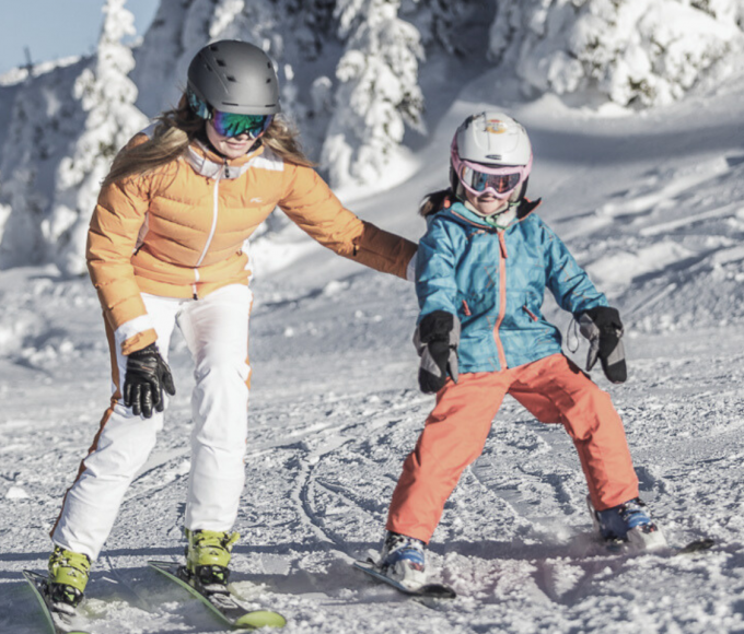 Children during a ski lesson on the practice slope in Maria Alm in the family-friendly Hochkönig ski area, Austria