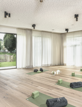 Fitness room with yoga mat in light colours