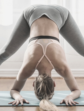 Fitness room with yoga mats and yoga ladies in light colours