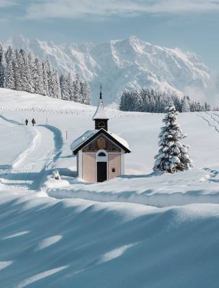 Winter landscape in Salzburger Land with snow-covered mountains and trees