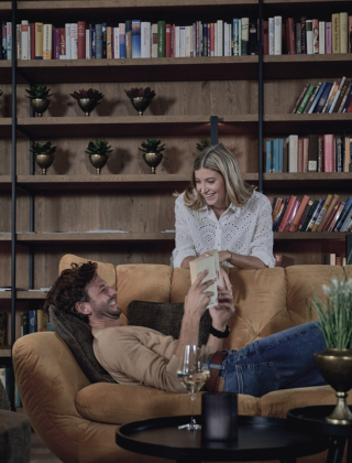 Couple in the cosy hotel lounge with a book in hand