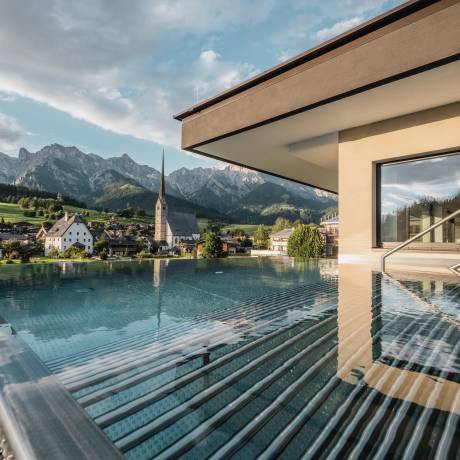 Outdoor pool the HOCHKÖNIGIN during the day in Maria Alm Wellnesshotel Luxury Hotel Family Hotel