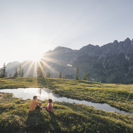 Couple in the mountains on an alpine meadow