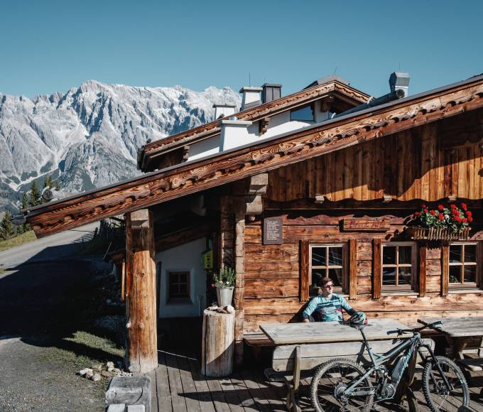 Alpine hut in the mountains with biker