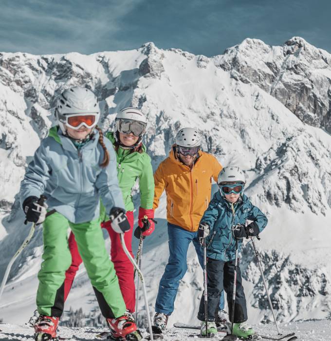 Family in the snow in the mountains skiing