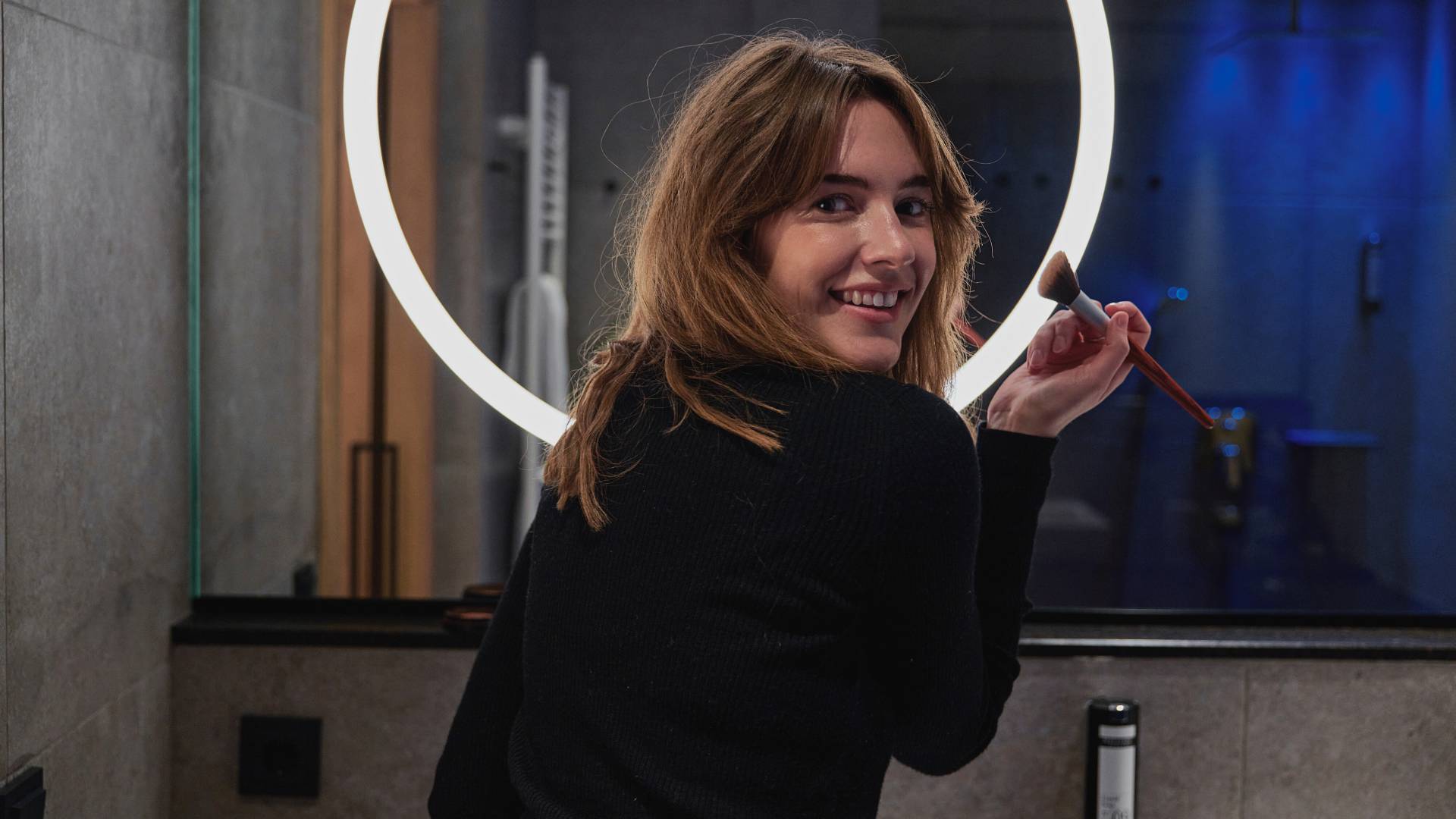 Woman in front of the bathroom mirror in the hotel of the HIGH QUEEN 